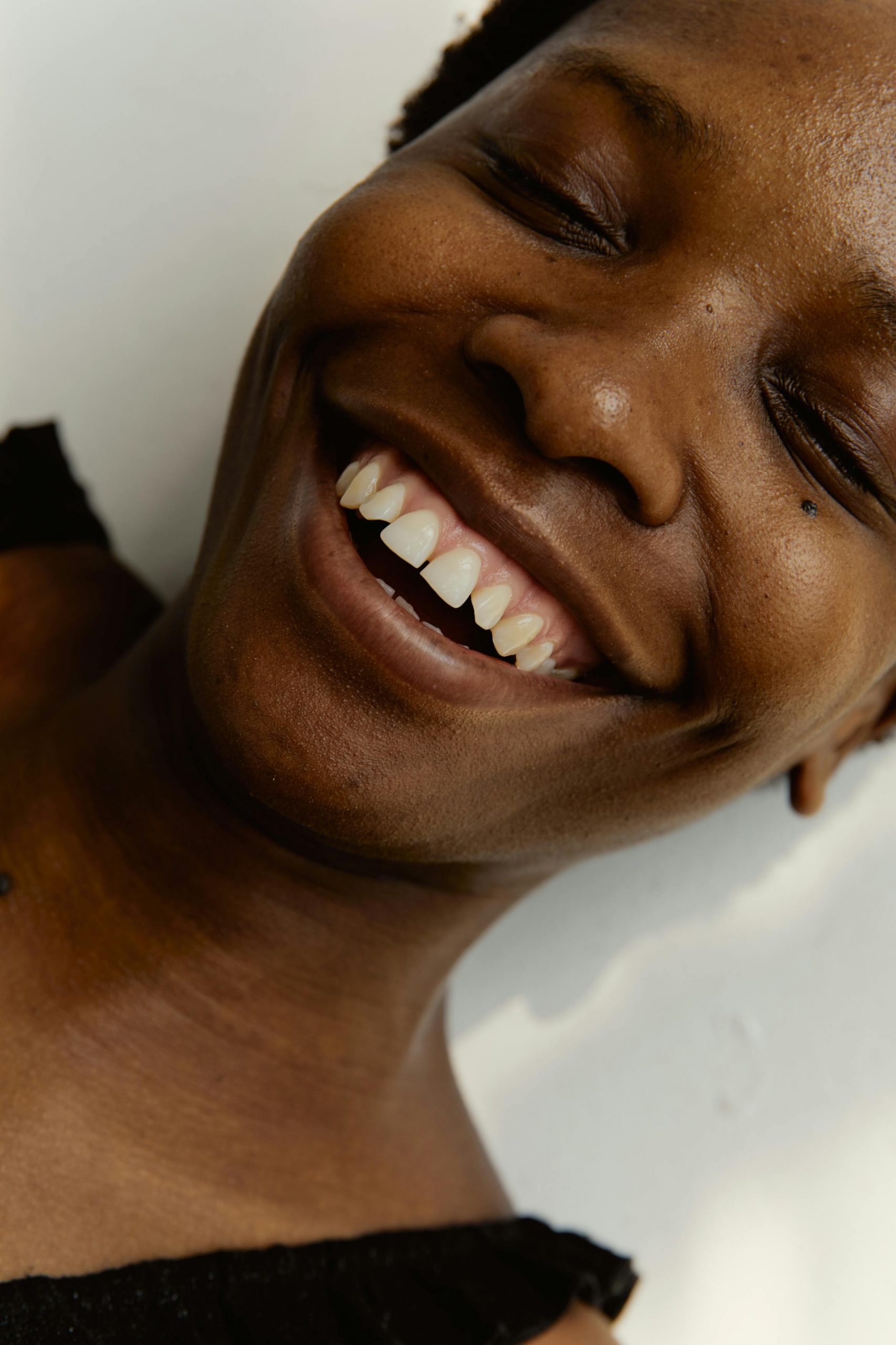 Close-up portrait of a smiling woman radiating happiness and warmth.